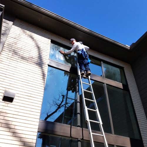 Window-cleaner-on-a-ladder